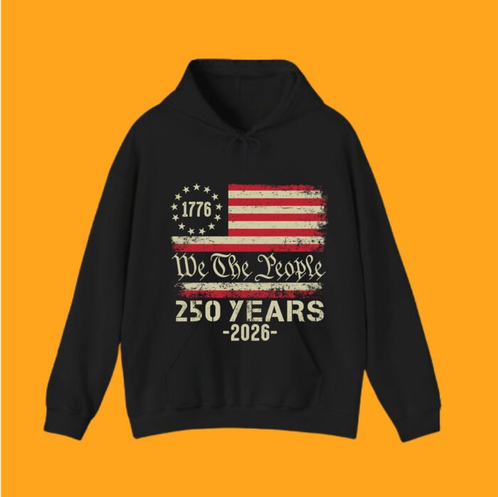 Front view of a patriotic black hoodie with a distressed American flag, 1776 circle stars, and We The People 250th anniversary branding.
