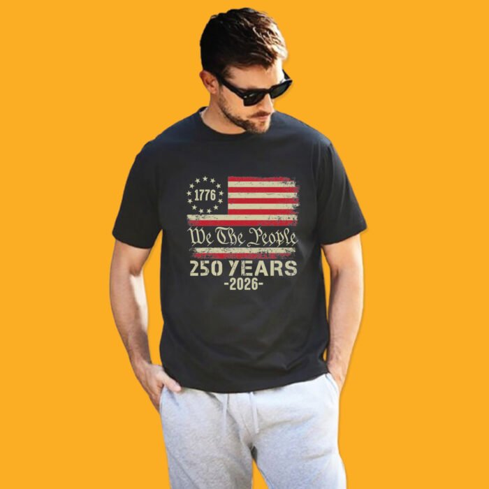 Unisex black t-shirt featuring a vintage Betsy Ross style flag with 1776, "We The People" script, and 250 Years - 2026 text