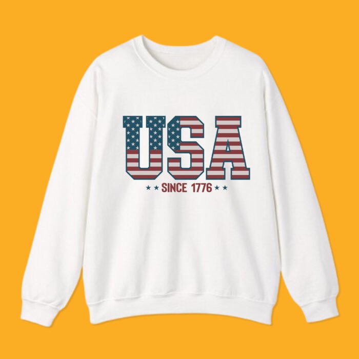 Classic white crewneck sweatshirt with retro "USA Since 1776" American flag block lettering.