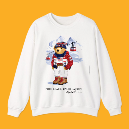 Man wearing white 2026 Winter Olympics Polo Bear graphic t-shirt against yellow background.