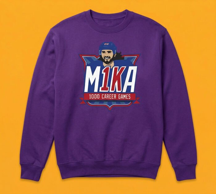 "A high-quality preview of a purple crewneck sweatshirt featuring a Mika Zibanejad 1000 career games commemorative design. The sweatshirt is displayed against a solid yellowish-orange background."